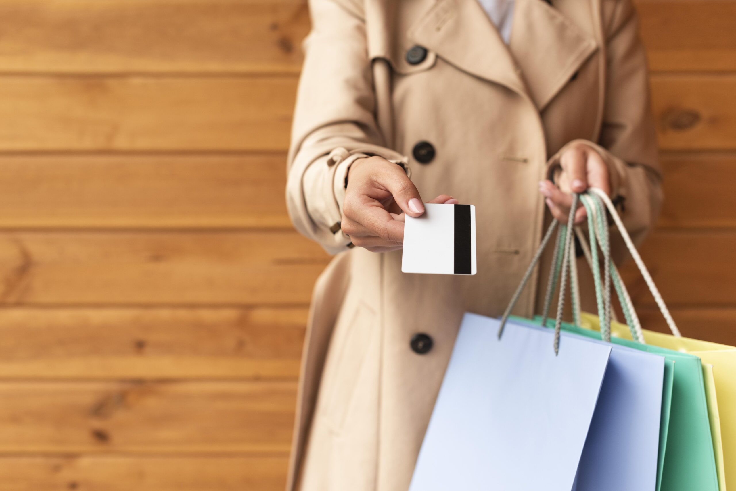 front-view-woman-with-lots-shopping-bags-offering-you-her-credit-card